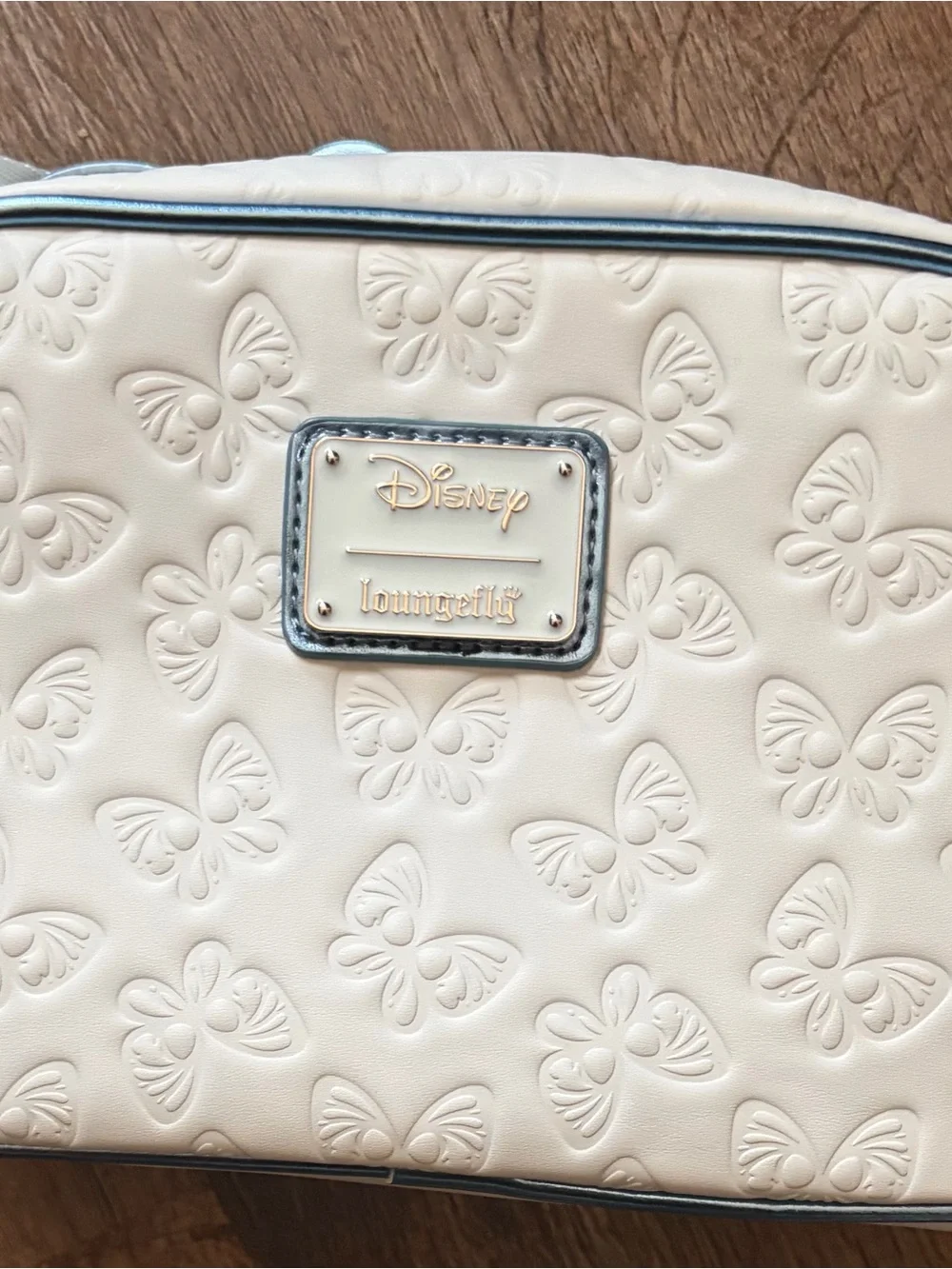 Loungefly Cream Crossbody Bag with Metallic Blue Bow Accent